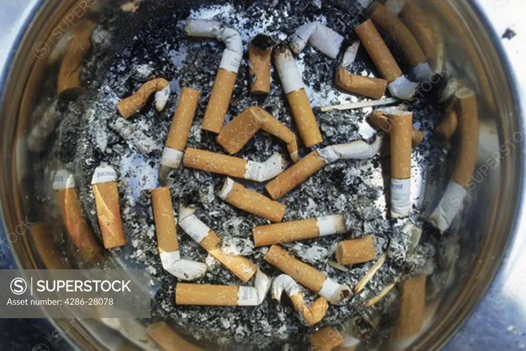Ashtray filled with cigerette butts and ashes