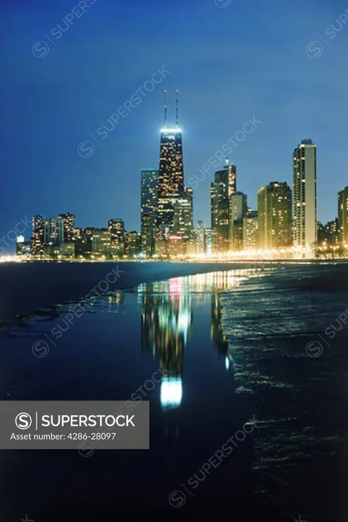 Cityscape of downtown Chicago business district  with Sears Tower at night on Lake Michigan shore in Illinois