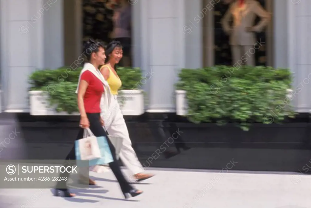 Two women with shopping bags on Rodeo Drive in Beverly Hills California