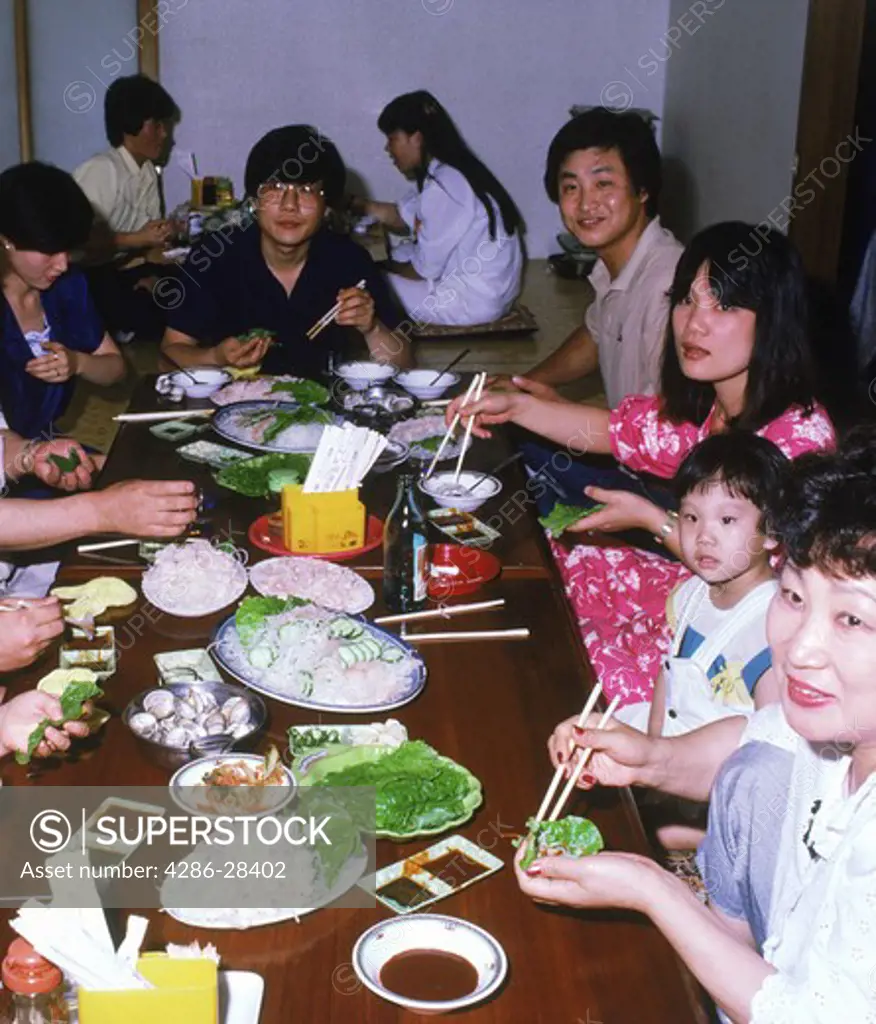 Korean families eating meal in seafood restaurant in South Korea