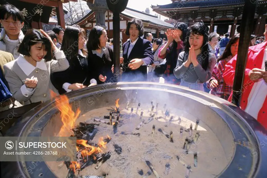 School children bathing in incense at Asakusa Temple from 7th Century in Tokyo