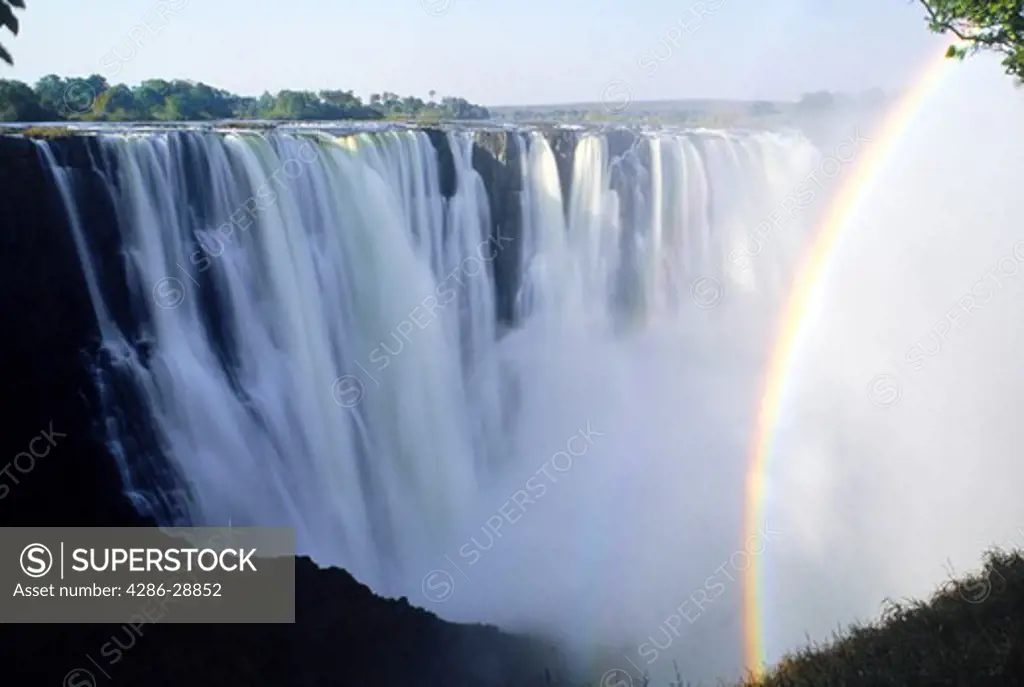 Rainbow across spray rising off Zambezi River at Victoria Falls from Zimbabwe