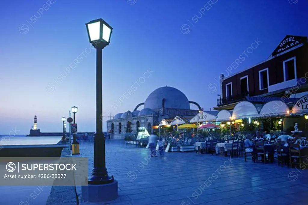 Lamplight and outdoor restaurants along waterfront at Chania Harbor on Crete