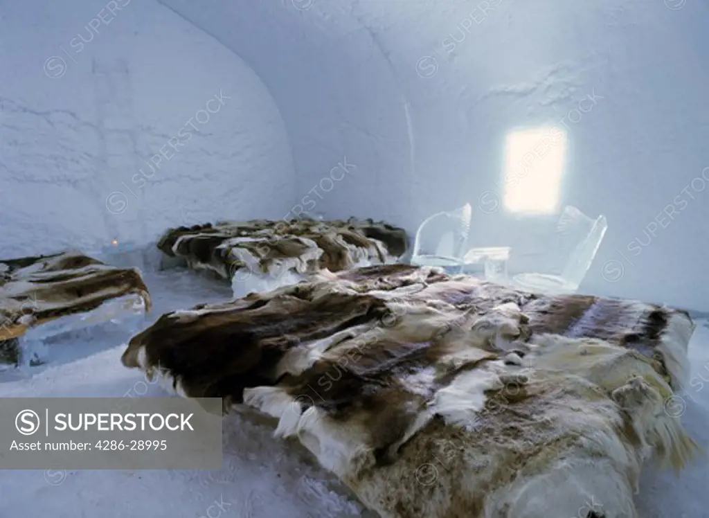 Reindeer skin blankets on beds of ice in  rooms of  Ice Hotel at Jukkasjarvi near Kiruna, Sweden