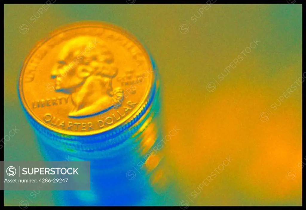 Stack of quarters with blue and yellow light.