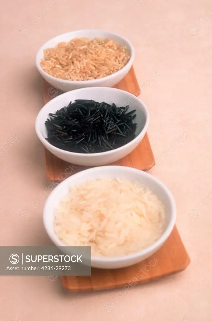 Still life portrait of three types of rice in three separate bowls. 