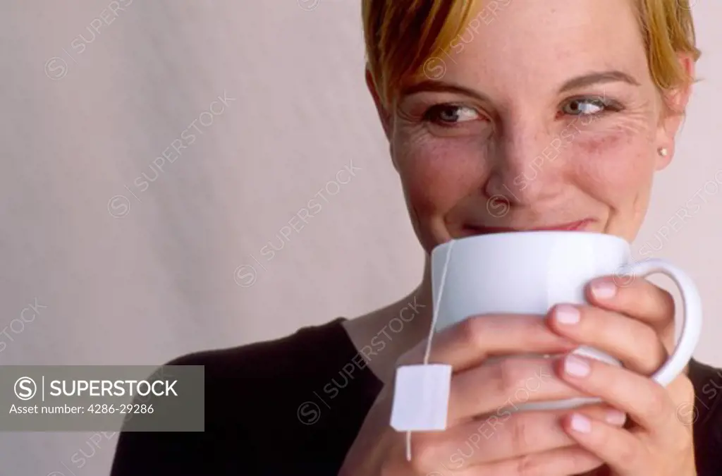 Woman enjoying a mug of hot tea