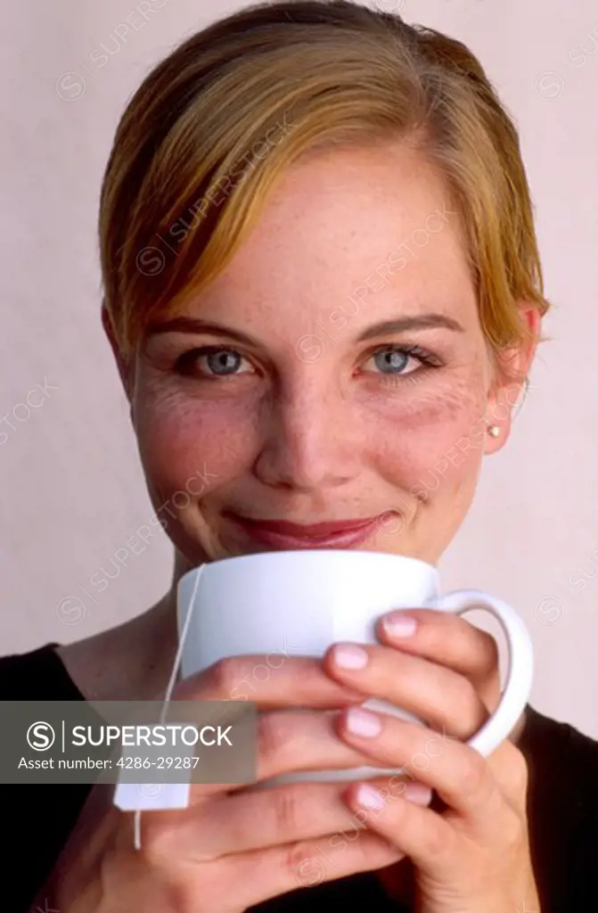Woman enjoying a mug of hot tea