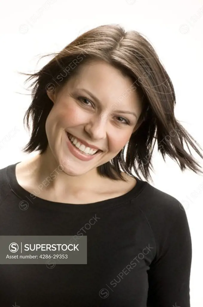 Portrait of smiling young brunette woman looking at the camera