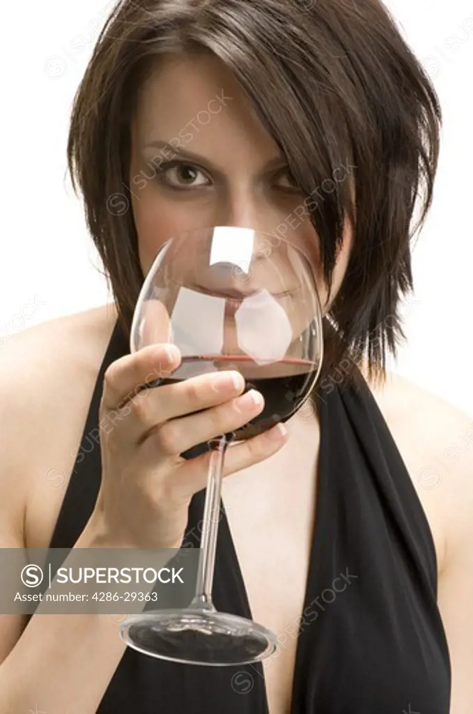 Woman with a snifter of alcoholic beverage