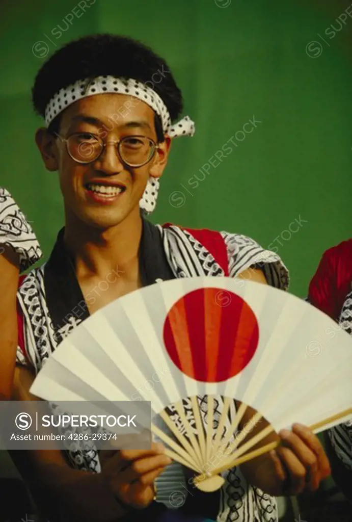 Japanese festival goer displays traditional fan, Nebuta Festival, Aomori.  Total Japan file contains 20,000 images from 40 shoots.