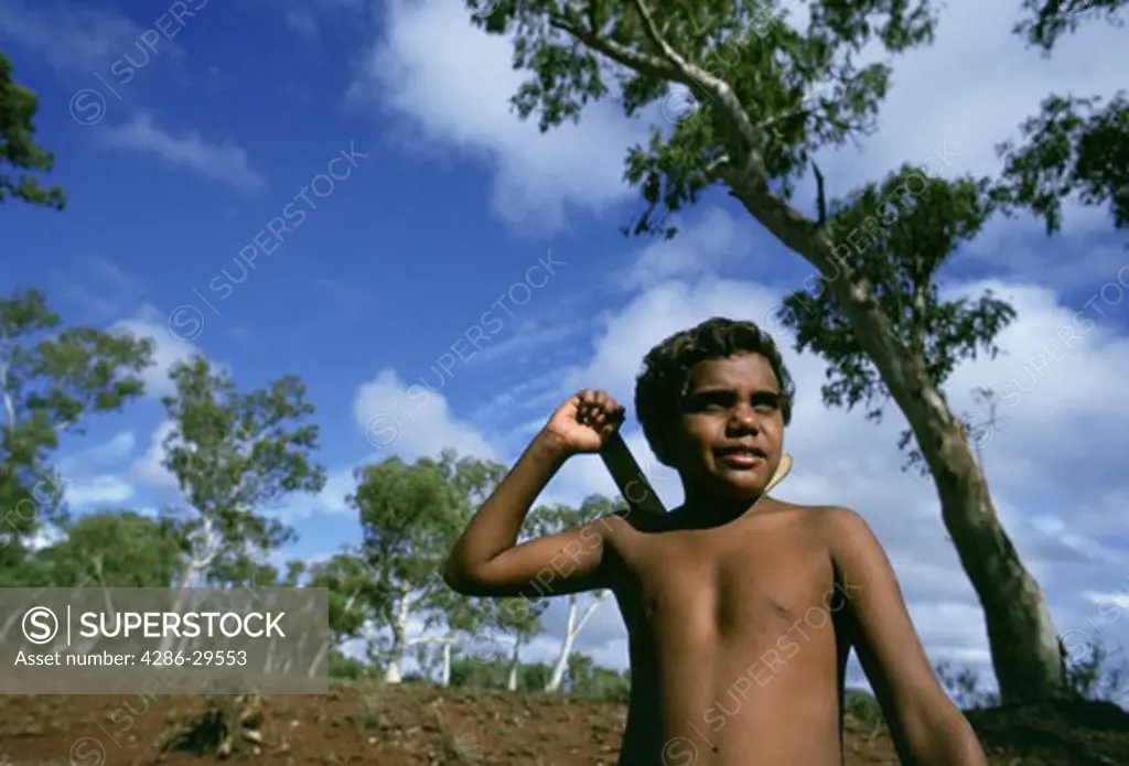Aborigine boy with boomerang, Australian outback