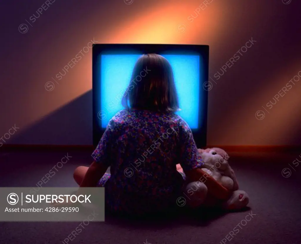 Young girl mesmerized by t.v.