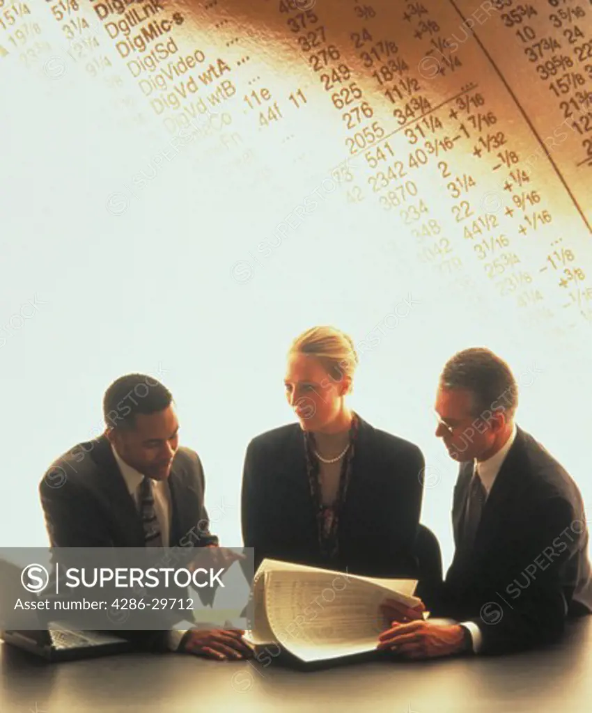 Three business people talking at conference table, with stock quotes in background.