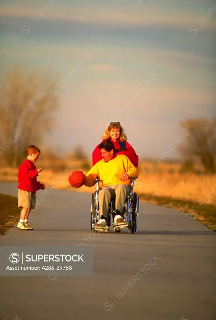 Physically challenged man with family.