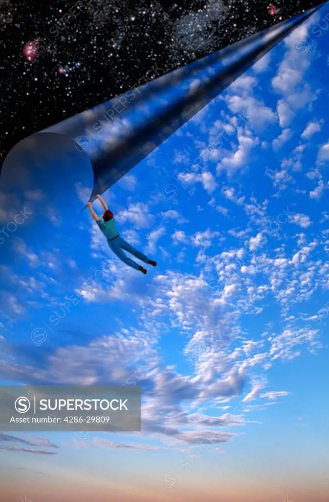 Computer generated illustration of a man hanging from the corner of the sky as he appears to pull or peel the daytime sky, clouds and atmosphere back to reveal stars in outer space.