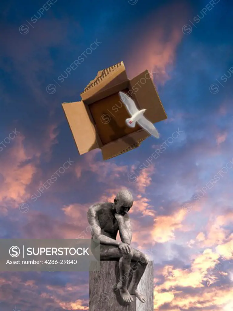 A white bird flies out of a cardboard box floating over a statue of a seated man thinking.