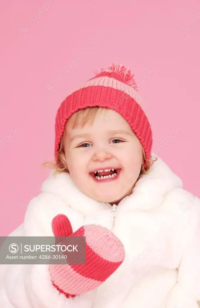 Young girl wearing hat and mittens