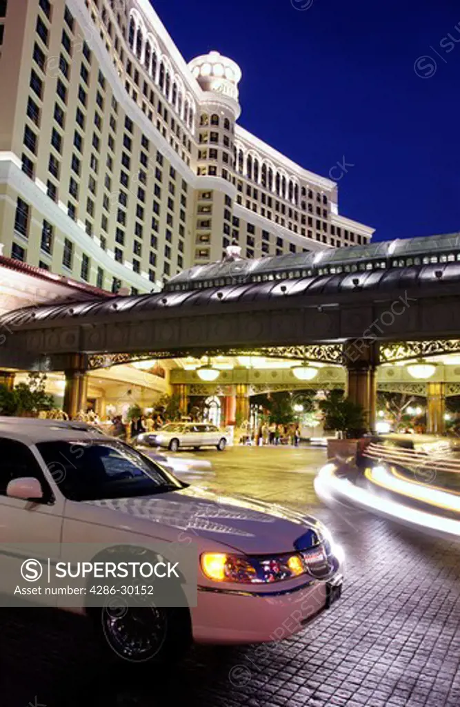 Exterior of Bellagio hotel at dusk with stretch limousine in foreground, Las Vegas, Nevada