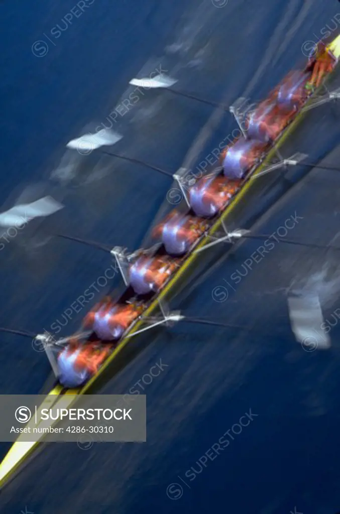 Blurred, aerial image of a crew team rowing in the Windemere Crew boat races on Montalke Cut, Seattle, Washington on opening day.