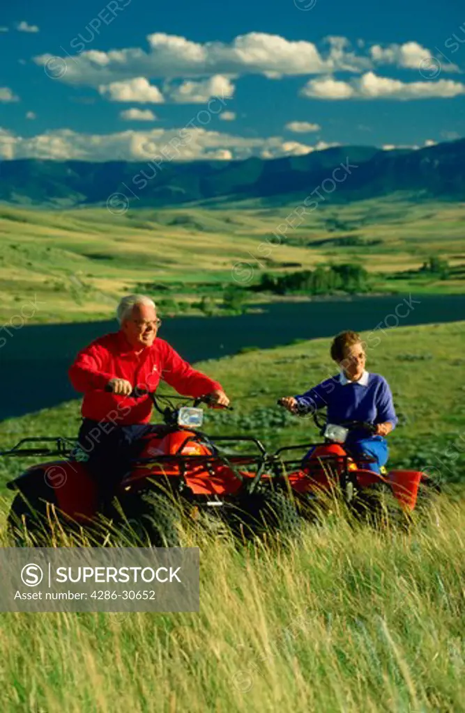 Seniors ride 4-wheelers near their retirement home at Cooney Lake, Montana.