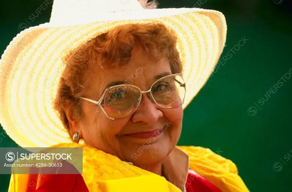 Senior woman with life jacket and fishing hat.