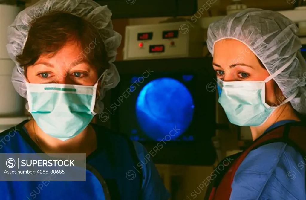 Registered nurses working in cardiac cath lab.