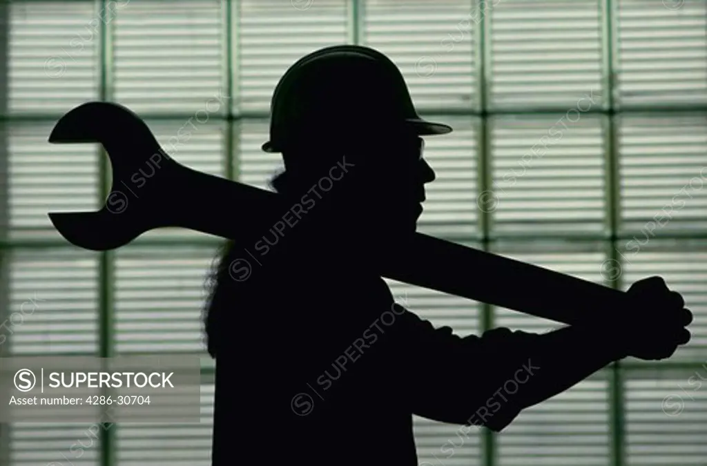 Worker silhouette carrying large wrench.