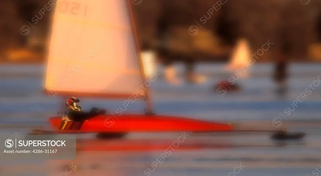 Blurred view of ice sailboat speeding across the ice on a frozen lake, Minnesota.