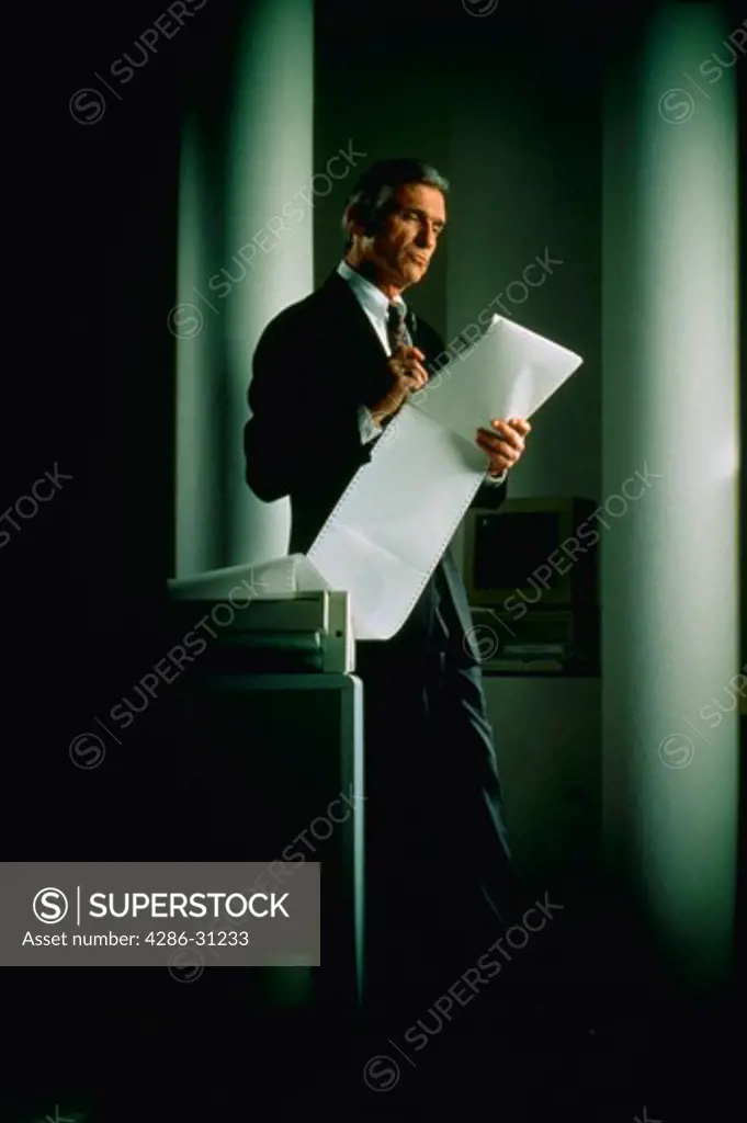 Businessman reviewing printout