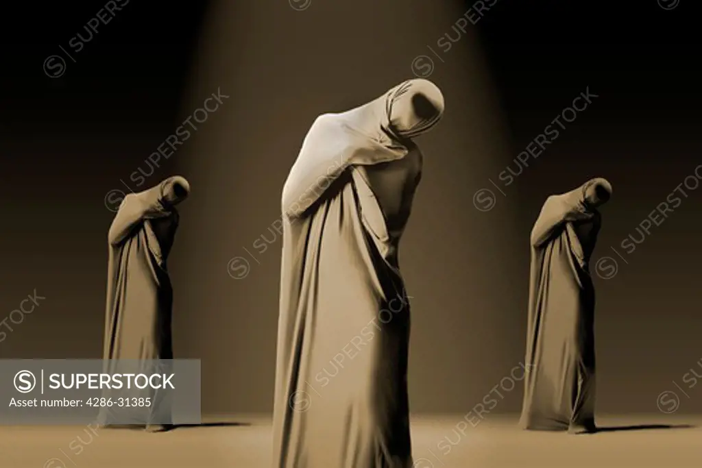 Three dancers wrapped in fabric standing with their heads cocked.