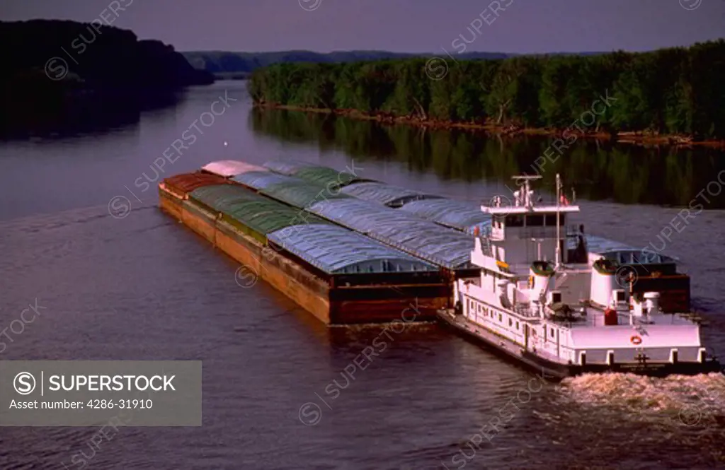 Tug boat pushing barges down Mississippi River near Marquette, Iowa.