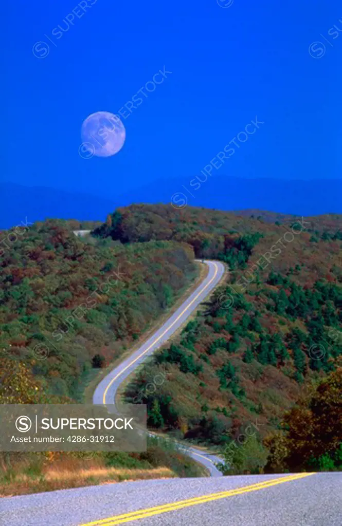Moon in daylight sky over Talimena Scenic Drive through Arkansas and Oklahoma.  Ouachita National Forest in fall.