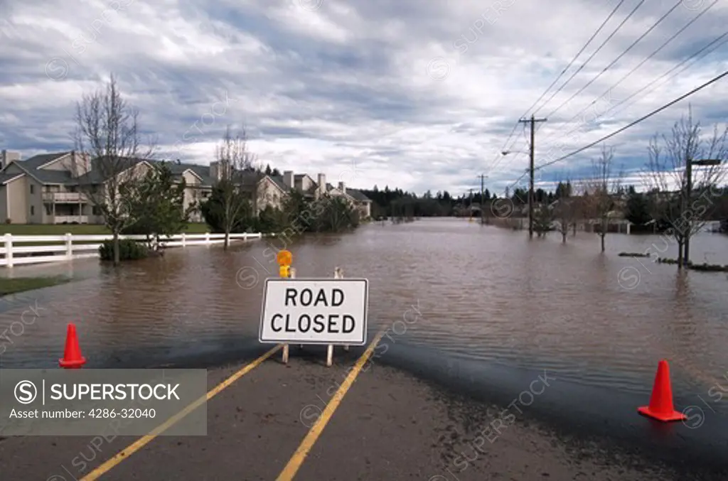 A sign marks a road closed due to flooding of the Tualatin River in Tualatin, Oregon.
