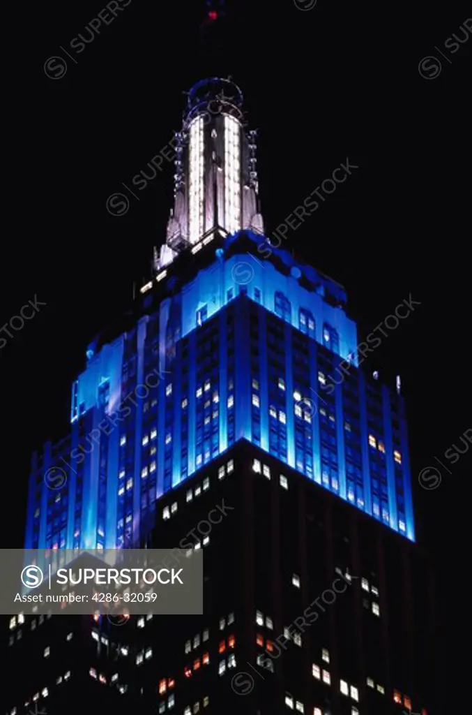 View of the Empire State Building at night in midtown New York City, New York.