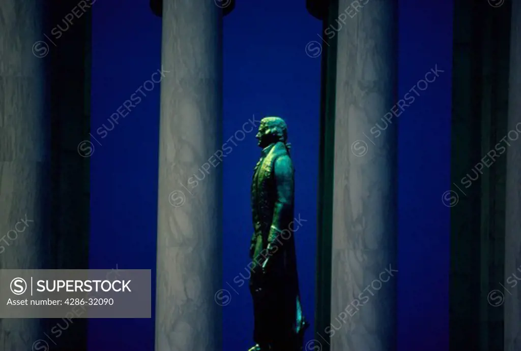 Bronze statue of Thomas Jefferson seen in profile between the columns of the Jefferson Memorial, Washington, DC.