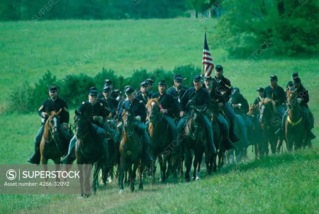 Civil War re-enactors as Union horse soldiers ride in reenactment of the Battle of Brandy Station, near Leesburg VA.