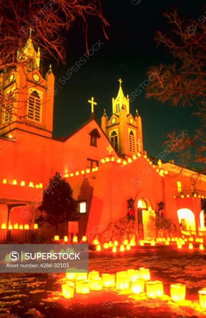 Candle luminaries light San Felipe de Neri Church on Christmas Eve in Old town Albuquerque, New Mexico.