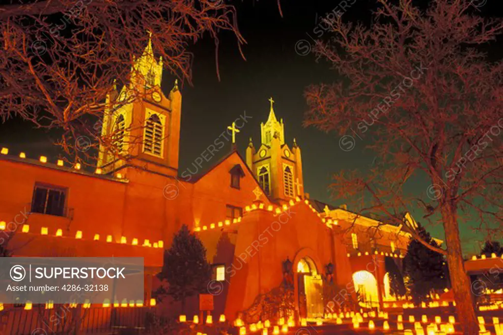 Evening shot of San Felipe de Neri Church with luminarias on Christmas Eve in Old Town, Albuquerque, NM.