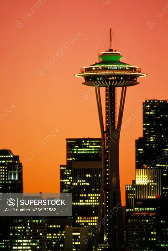 Seattle skyline with space needle and citylights at sunrise.