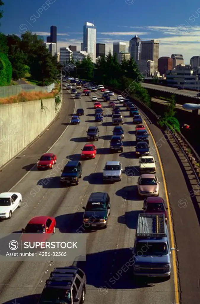Overhead view of traffic during rush hour on Interstate 5 with Seattle, Washington skyline in background.