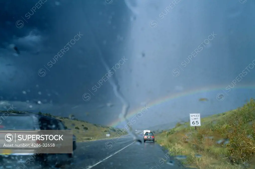 Seen through a car windshield, summer thunder and hailstorm delays flow of traffic on Interstate Highway 25, south of Pueblo, Colorado.  USA