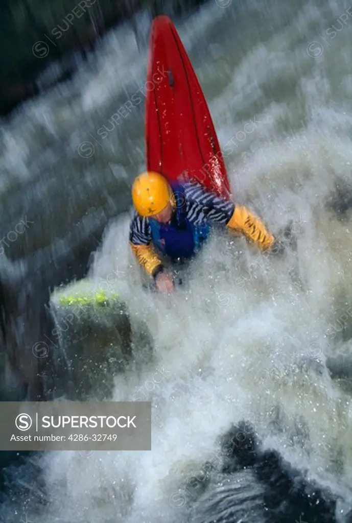 Man kayaking in white water on the St. Vrain River, Rocky Mountains.