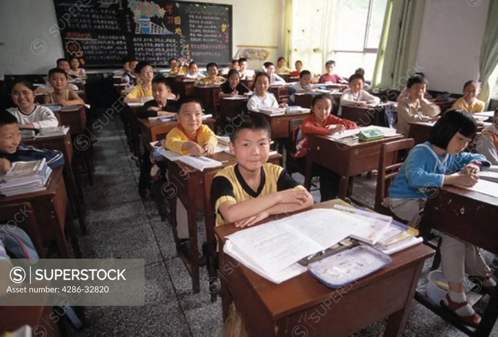 First grade class; children at desks; boy at center; elementary school; Chongqing, China, Asia; 041603