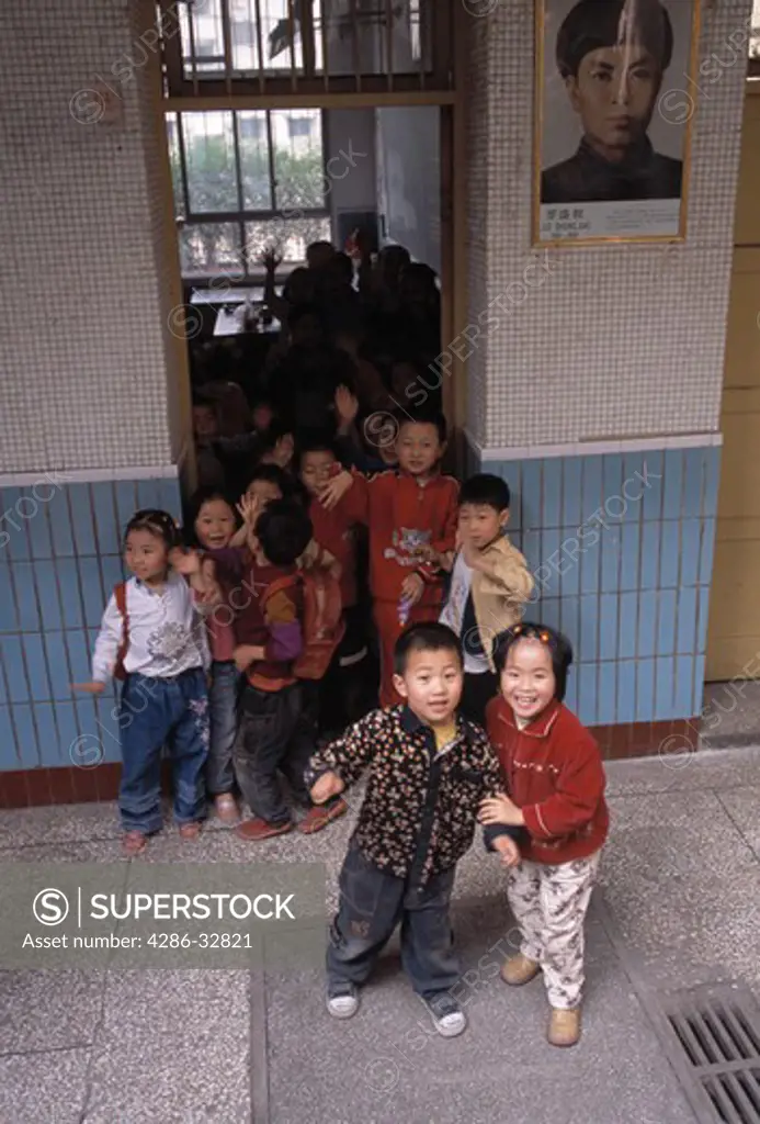 Children at door of first grade classroom; neighborhood elementary school; Chongqing, China, Asia; 041603