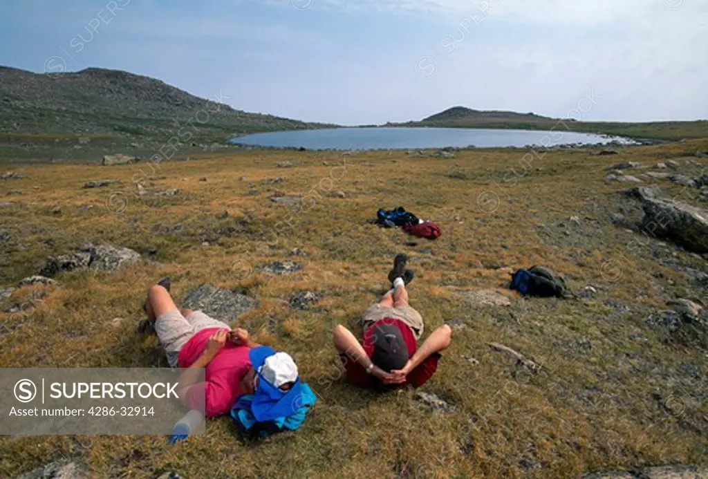 Two hikers reclining on tundra, Eagles Nest Wilderness, CO