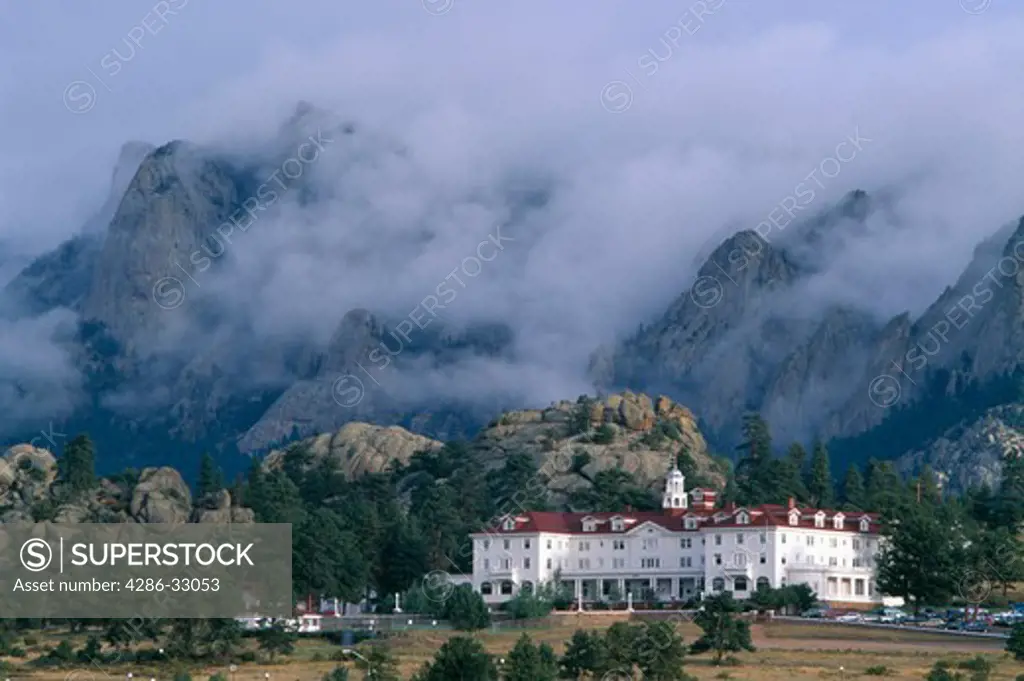 Storm clouds surround mountain-side above historic Stanley Hotel, Estes Park, CO