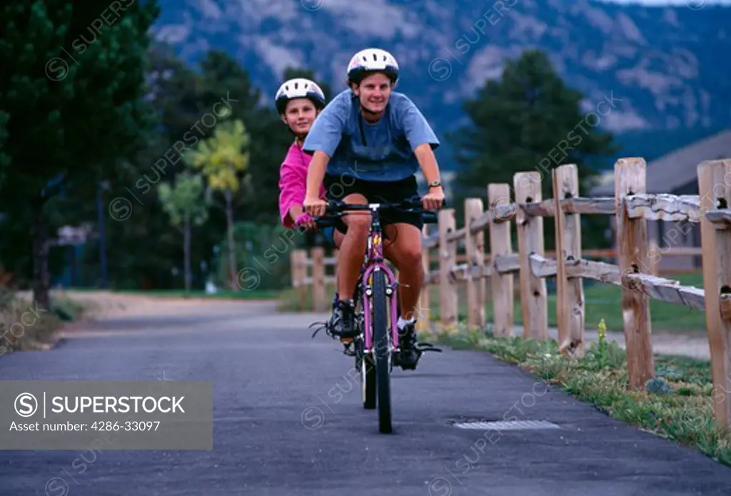 A mother and daughter enjoy a tandem bike ride in Estes Park, CO