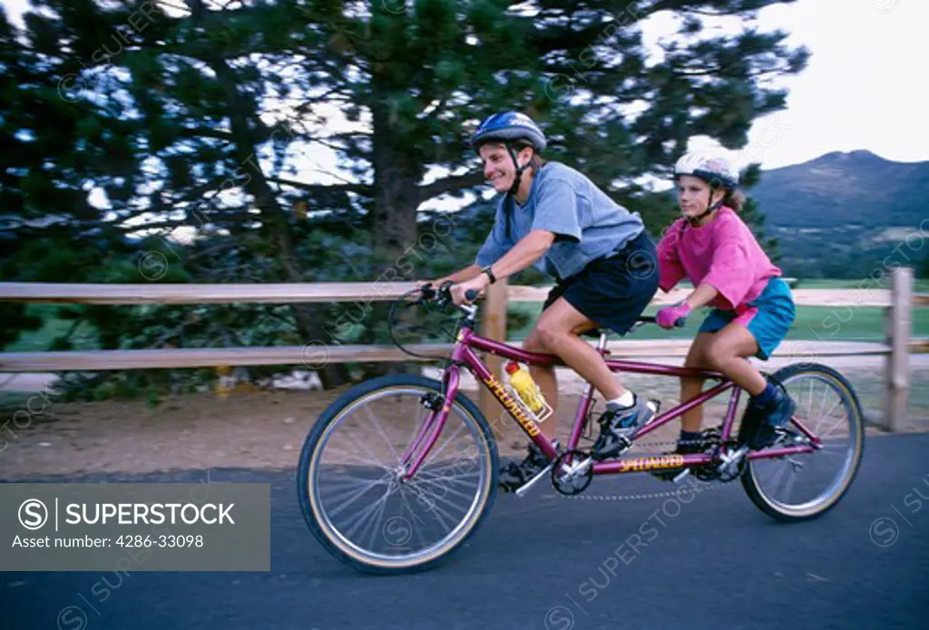A mother and daughter enjoy a tandem bike ride in Estes Park, CO