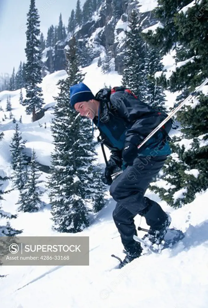 Man having fun while snowshoeing downhill, Rocky Mtn Nat'l Park, CO